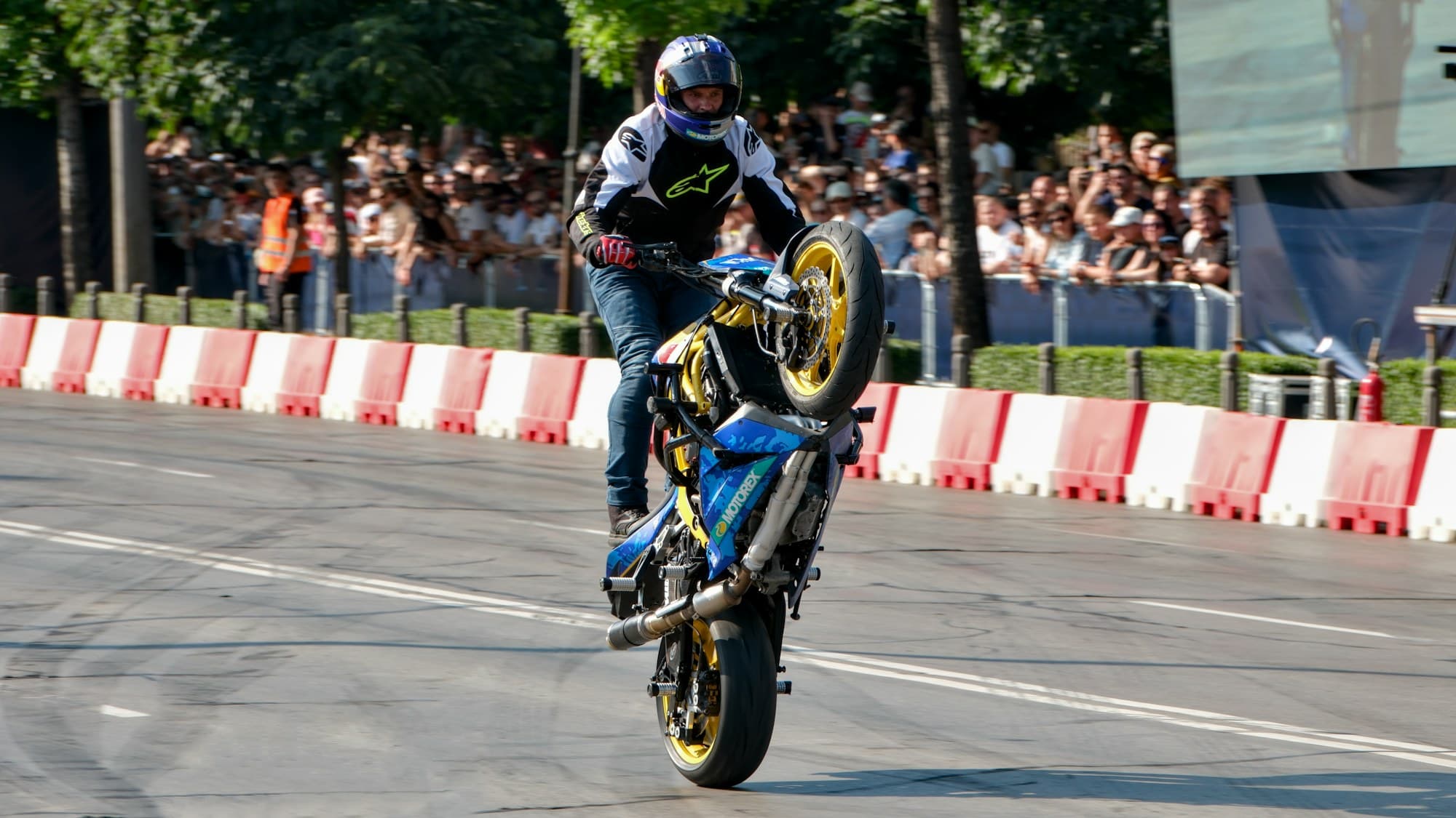 A branded motorsport roadshow activation draws a street crowd