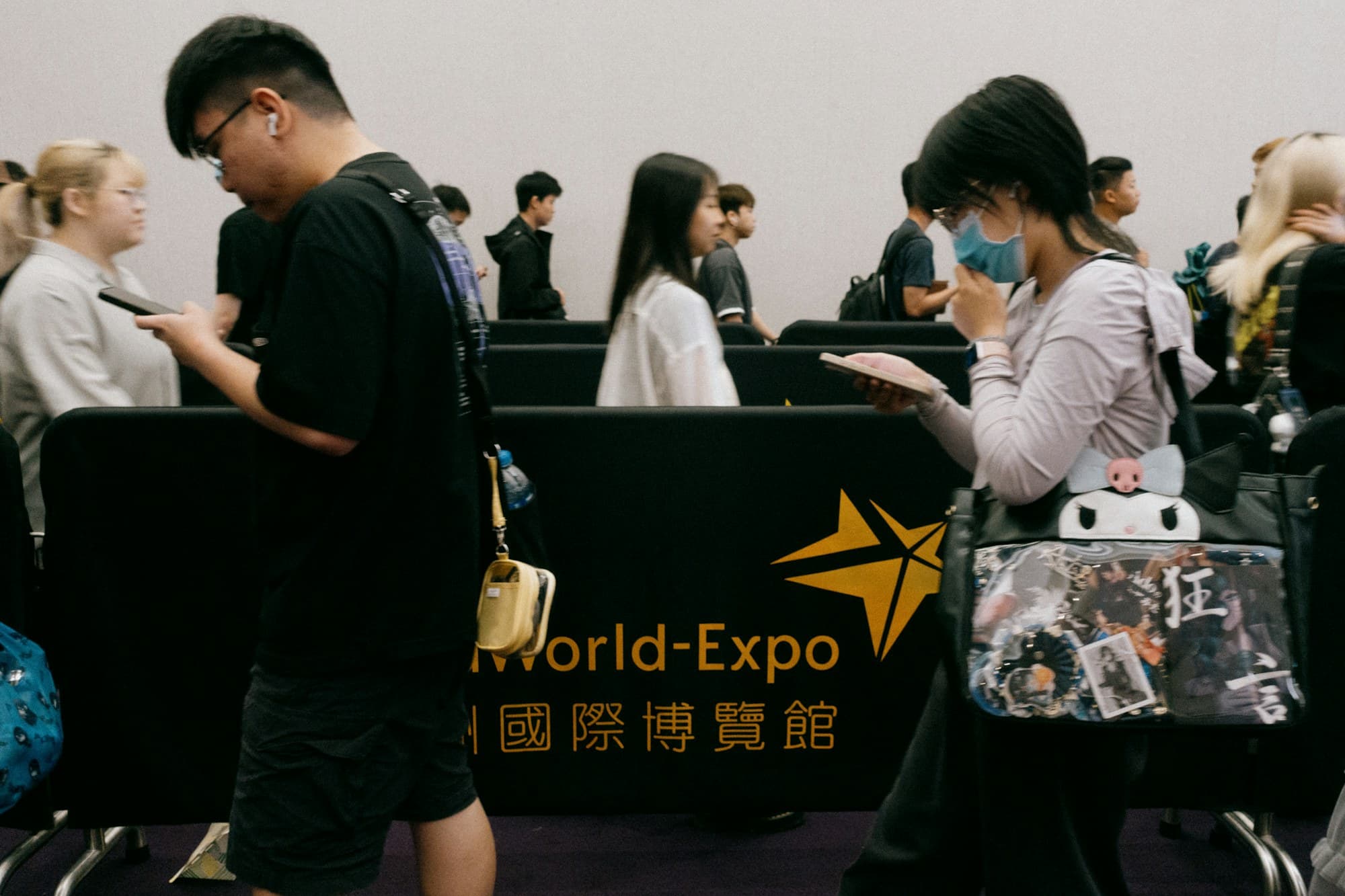 Guests queue at a registration desk inside a convention centre