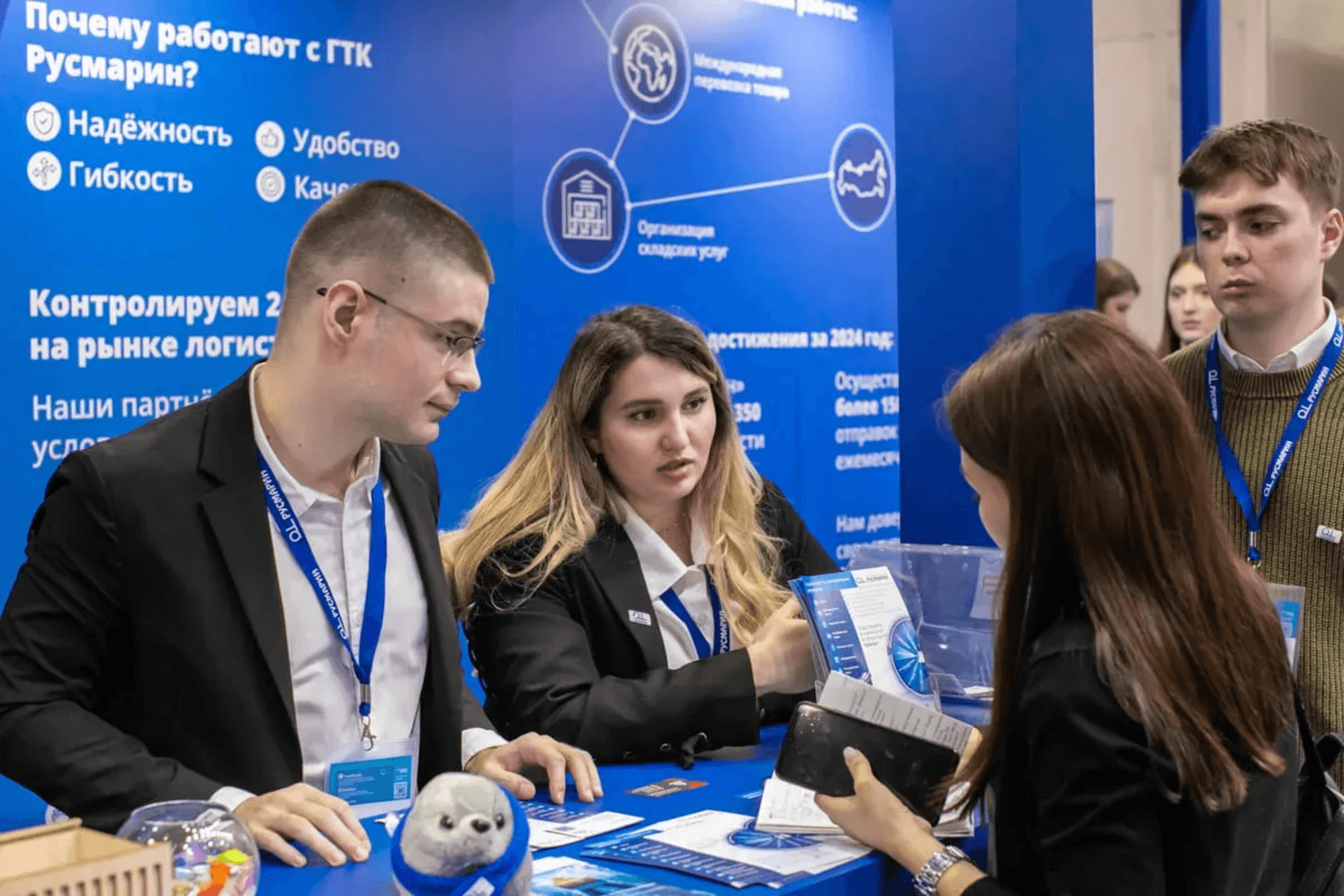 Corporate representatives network at a trade show exhibition booth