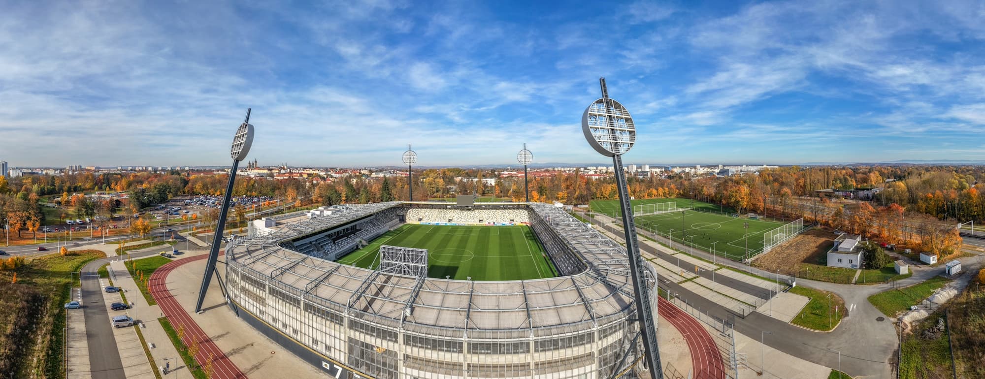 An aerial drone view of a large modern stadium venue